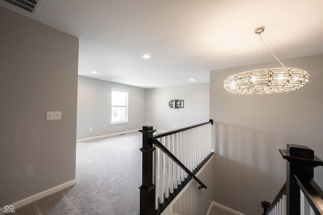 staircase with carpet floors, recessed lighting, visible vents, and baseboards