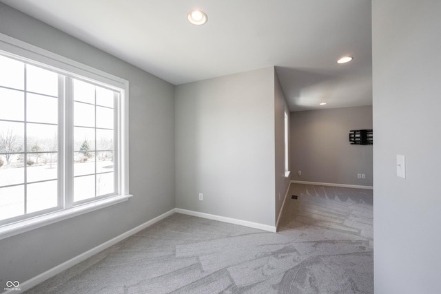 carpeted spare room featuring recessed lighting and baseboards