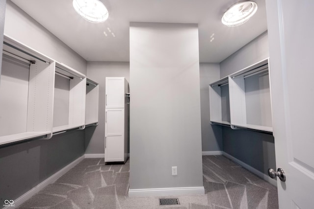 spacious closet with carpet and visible vents