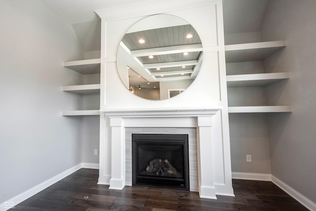 interior details featuring built in shelves, a fireplace, baseboards, and wood finished floors