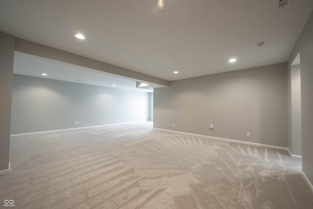 finished basement featuring recessed lighting, light carpet, and baseboards