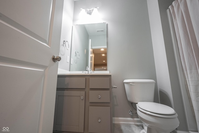 bathroom with toilet, baseboards, visible vents, and vanity