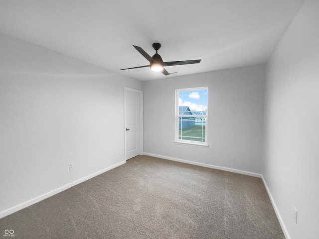 empty room with carpet, ceiling fan, and baseboards