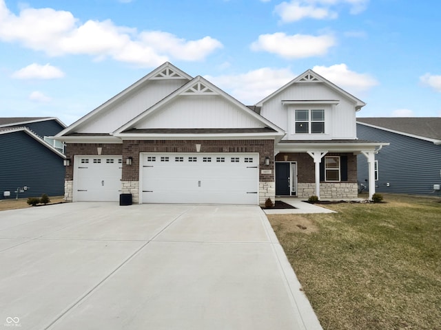 craftsman house featuring driveway, stone siding, an attached garage, covered porch, and a front yard