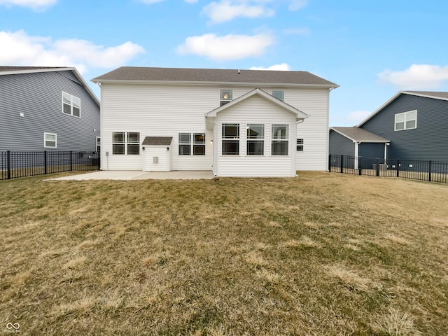 back of house with a fenced backyard, a lawn, and a patio