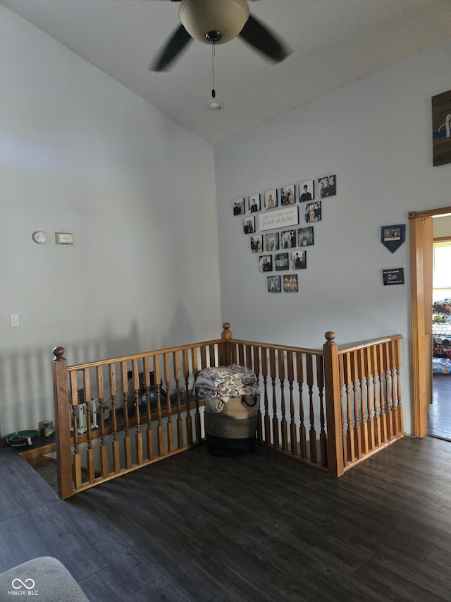 empty room with a ceiling fan and dark wood finished floors