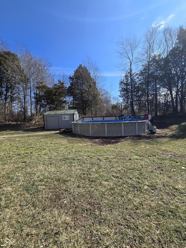 view of yard with an outdoor pool, an outdoor structure, and a shed