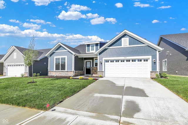 19714 Highclere Ln, Sheridan, IN 46069 - craftsman-style home featuring an attached garage, driveway, a front lawn, and stone siding