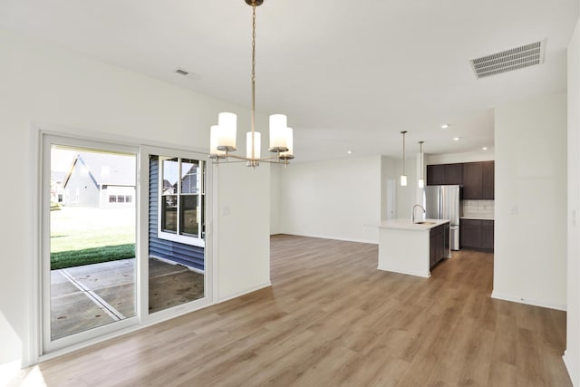 19714 Highclere Ln, Sheridan, IN 46069 - unfurnished dining area with recessed lighting, a notable chandelier, visible vents, and light wood-style flooring