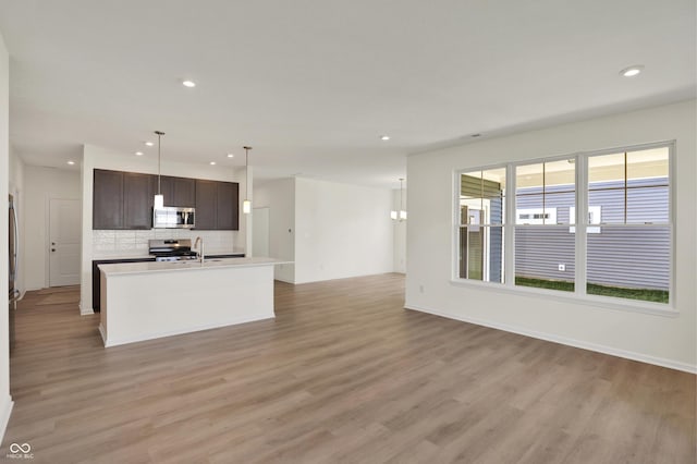 19714 Highclere Ln, Sheridan, IN 46069 - kitchen featuring light wood-style floors, recessed lighting, decorative backsplash, and appliances with stainless steel finishes