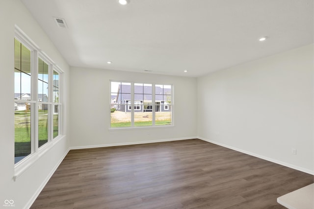 19714 Highclere Ln, Sheridan, IN 46069 - empty room featuring dark wood-style floors, visible vents, and plenty of natural light