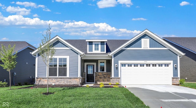 19714 Highclere Ln, Sheridan, IN 46069 - craftsman-style home with driveway, a front lawn, stone siding, and a garage