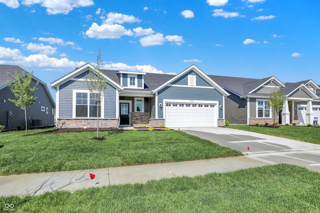 19714 Highclere Ln, Sheridan, IN 46069 - craftsman inspired home featuring an attached garage, driveway, a front lawn, and stone siding