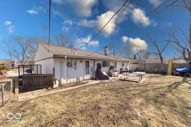 back of property with fence and a patio