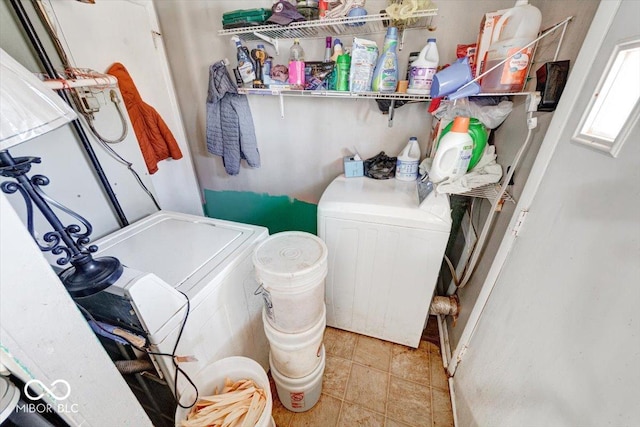 laundry room featuring laundry area, separate washer and dryer, and light tile patterned flooring