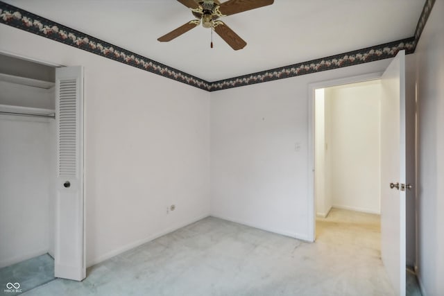 unfurnished bedroom featuring ceiling fan, a closet, baseboards, and carpet flooring