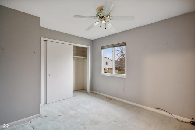 unfurnished bedroom with light carpet, a closet, visible vents, and baseboards