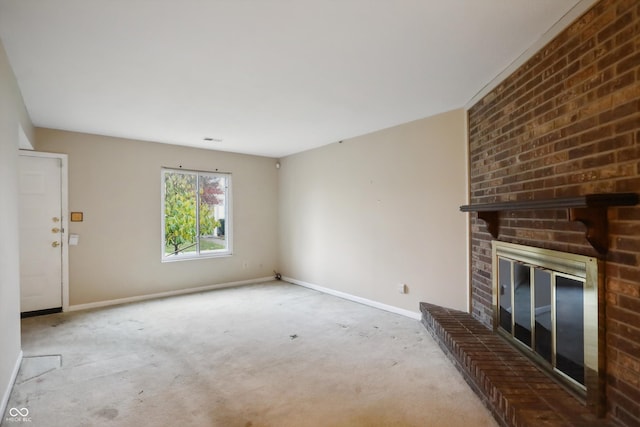 unfurnished living room featuring a brick fireplace, baseboards, and light colored carpet