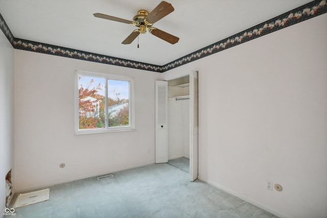 unfurnished room featuring light carpet, ceiling fan, and visible vents