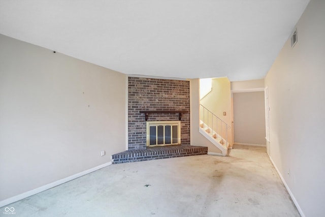 unfurnished living room featuring a brick fireplace, visible vents, and baseboards