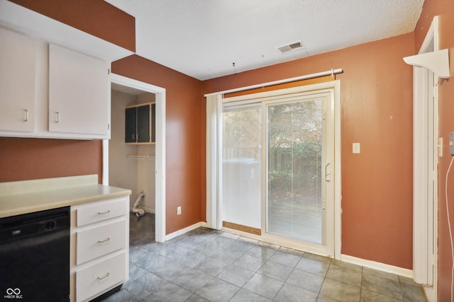 kitchen featuring visible vents, white cabinetry, baseboards, light countertops, and dishwasher