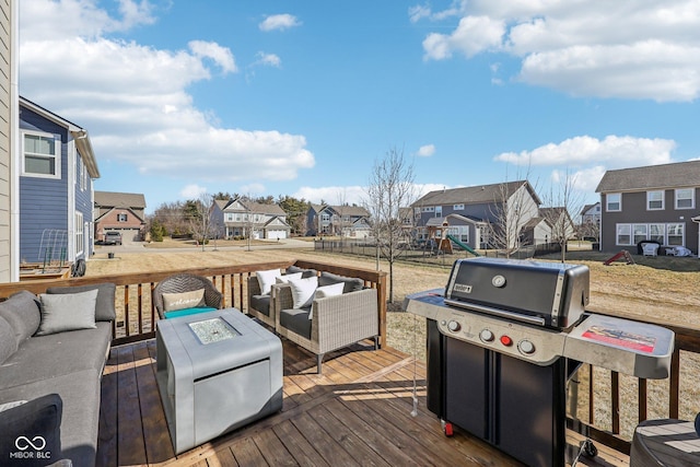 deck featuring a residential view, grilling area, and an outdoor living space with a fire pit