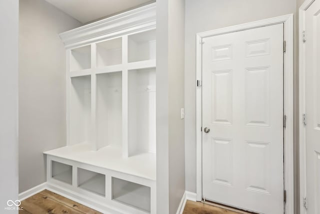 mudroom featuring wood finished floors and baseboards