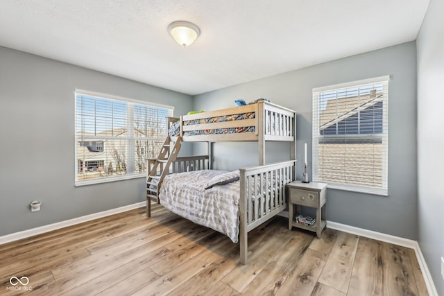 bedroom featuring baseboards and wood finished floors