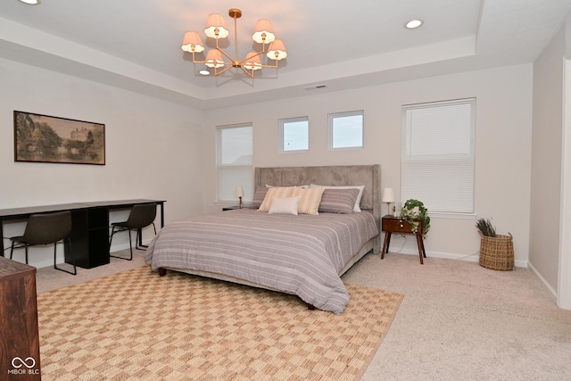 bedroom with carpet floors, a tray ceiling, recessed lighting, a chandelier, and baseboards