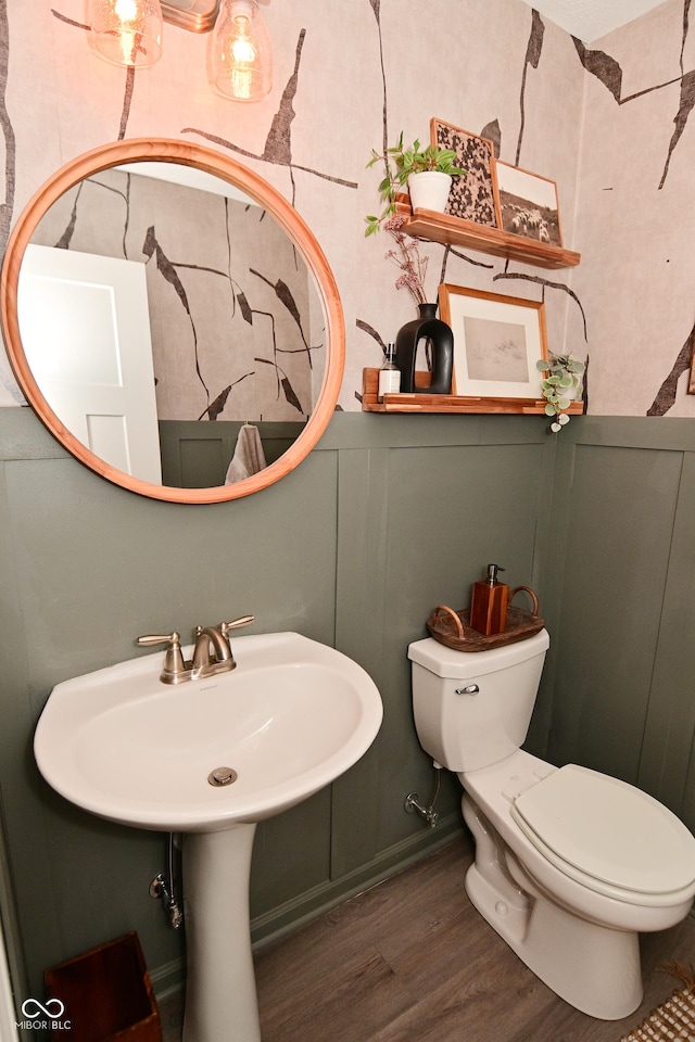 half bath with wood finished floors and toilet