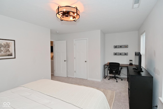 bedroom with light colored carpet, visible vents, and baseboards