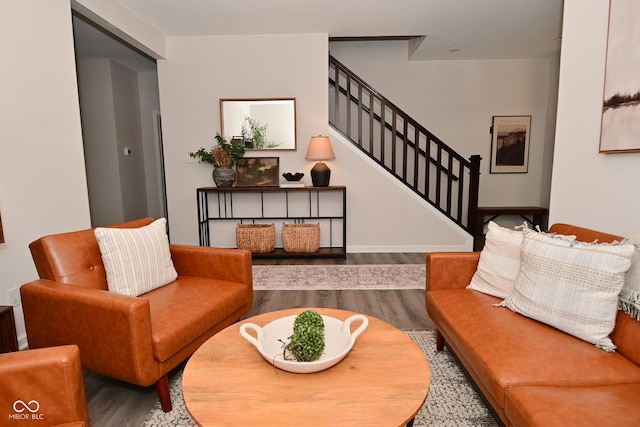 living area with stairs and wood finished floors