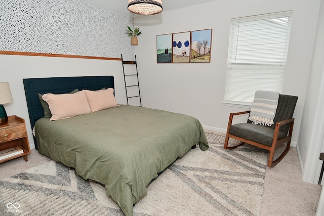 bedroom featuring carpet and baseboards