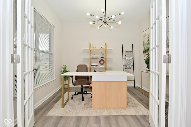 home office featuring a chandelier, french doors, light wood-style flooring, and baseboards