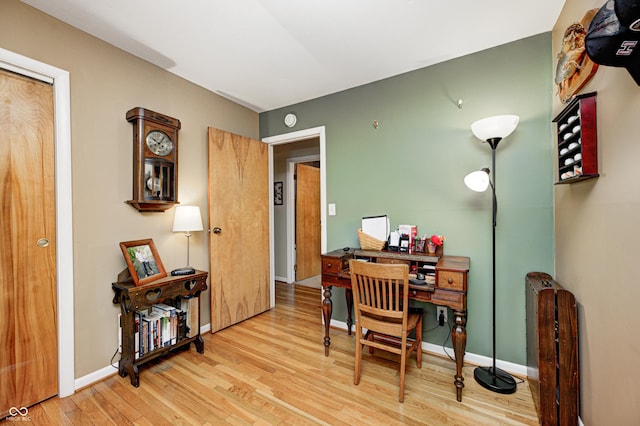 office area featuring baseboards and wood finished floors