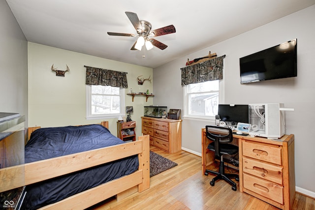 bedroom with ceiling fan, light wood-type flooring, and baseboards