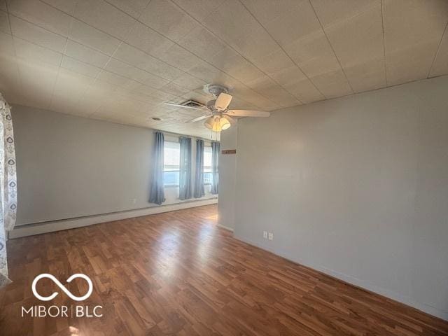 spare room with a ceiling fan and wood finished floors