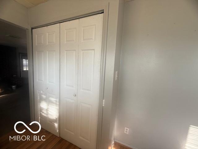 unfurnished bedroom featuring a closet and wood finished floors