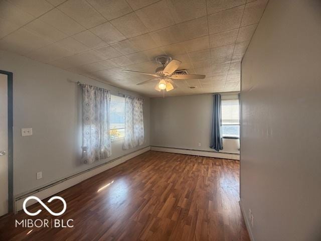 unfurnished room featuring a ceiling fan, wood finished floors, baseboard heating, and a baseboard radiator