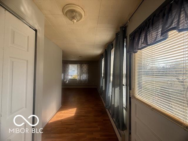 corridor with dark wood-style flooring