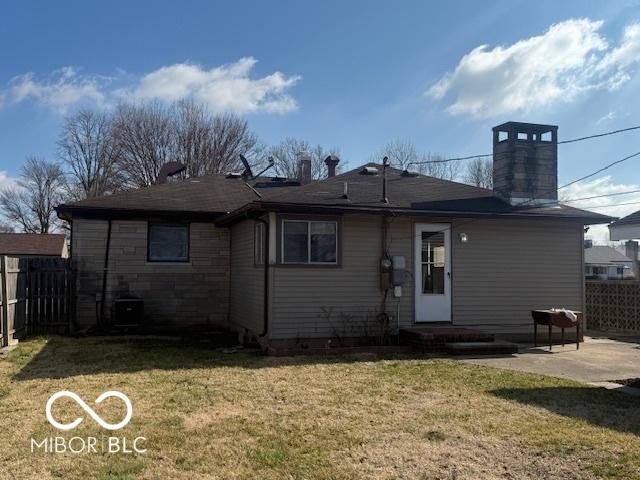 rear view of property with a patio, a lawn, central AC, and fence