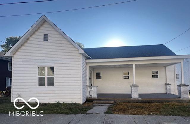 back of property featuring covered porch