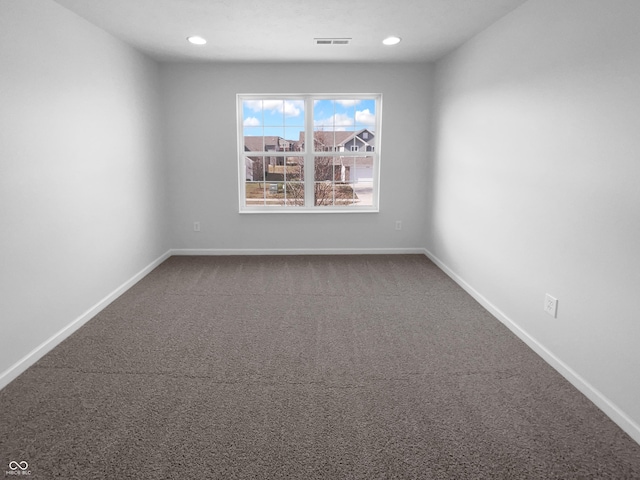 empty room with carpet, visible vents, baseboards, and recessed lighting