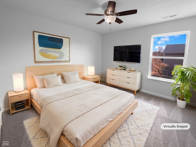 bedroom with carpet floors, baseboards, visible vents, and a ceiling fan