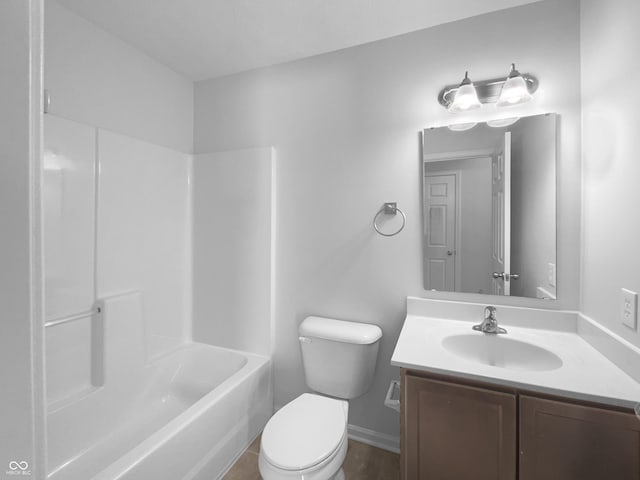 bathroom with baseboards, shower / tub combination, vanity, and toilet