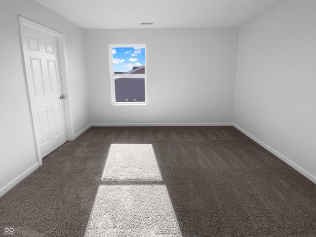 carpeted empty room with visible vents and baseboards