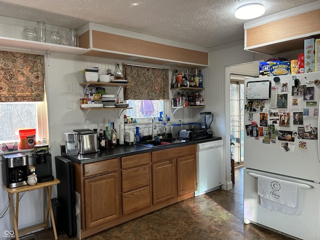 kitchen with open shelves, white appliances, brown cabinetry, and a sink