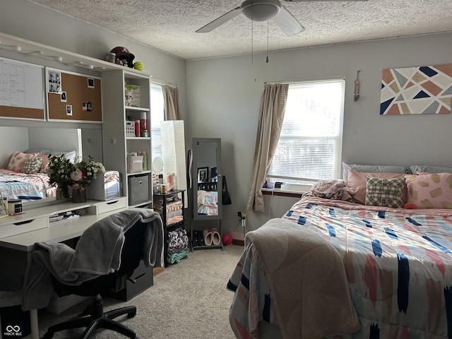 bedroom with light carpet, ceiling fan, and a textured ceiling