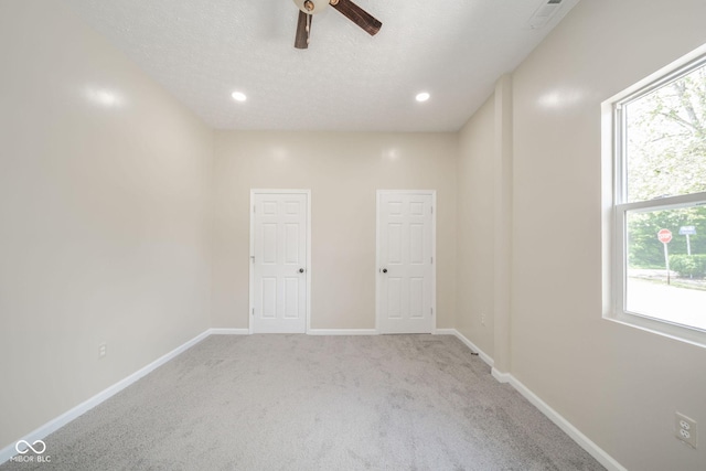 carpeted empty room with recessed lighting, ceiling fan, a textured ceiling, and baseboards