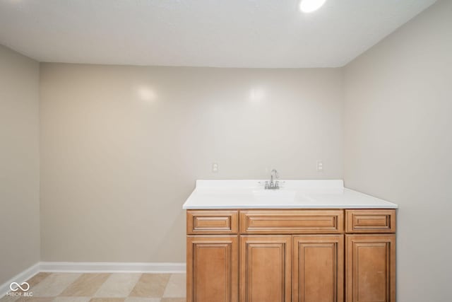 bathroom featuring baseboards and vanity